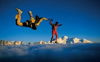 Two Skydriver Parachuting Through Out Many Clouds Photos