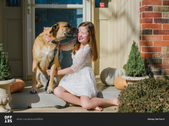 Dog Licking A Girl S Face Outside On The Front Porch Stock Photo Wallpaper