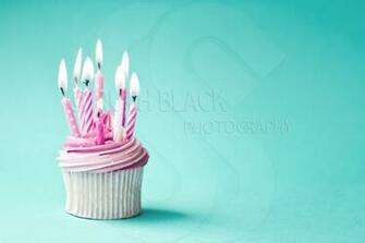 Pink BirtHDay Cupcake Against A Blue Background Royalty Stock