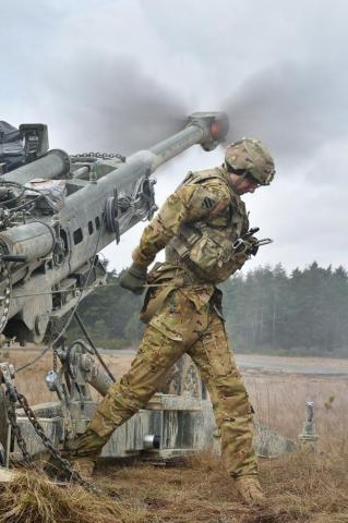U S Army Spc Vincent Ventarola Pulls The Lanyard On A M777