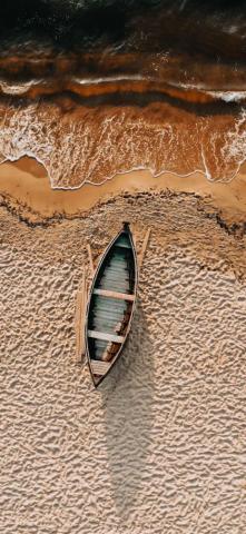 Brown And White Boat On Sand iPhone Wallpaper