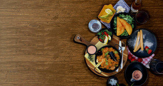 Delicious Dining Experience With A Friends Family Food Table Wallpaper