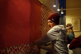 An Alpha Chi Omega Puts Up Wallpaper In Their Assigned Room Sigma