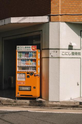 Orange Vending Machine Near Building Photo Japan Image On