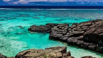 Tropical Beach Surrounded By Black Rocks Rarotonga Cook Islands