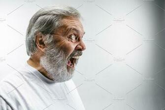 The Senior Emotional Angry Man Screaming On White Studio