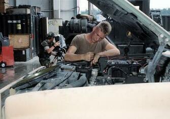A Seabee Performs Preventive Maintenance On Truck While