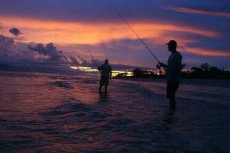 Beach Inn Fishing In The Surf With A Beautiful Sunset As Background