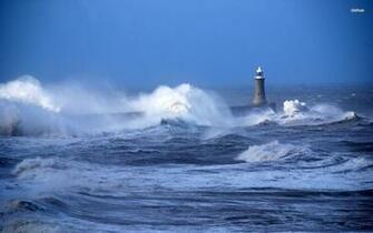 Rough Waves Hitting The Lighthouse Wallpaper
