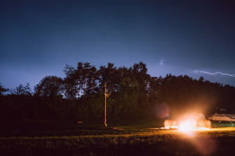 Bright Light By The House Near Trees Photo Image