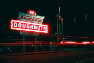 Red And White Unks Coffee Building During Night Time Photo