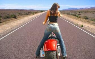 Woman In Black Thick Strap Shirt And Blue Jeans Riding Red Cruiser