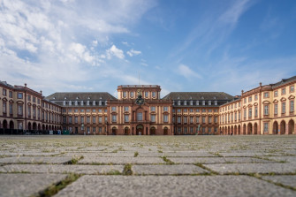 A Large Building With Clock On The Front Of It Photo