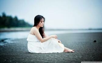 Girl Sitting On The Beach UltraHD Wallpaper
