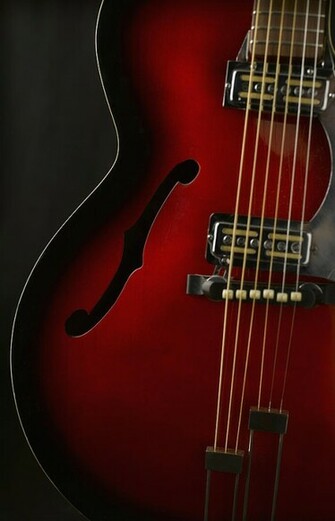 Guitar Against Black Background Close Up Photograph