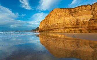 Rusty Rock On Sandy Beach Wallpaper