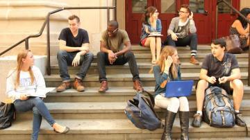 A Group Of Students Sitting On Steps College