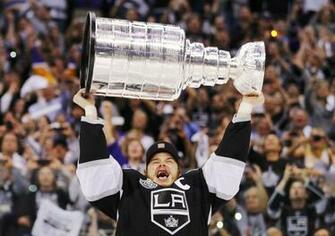 Los Angeles Kings Captian Dustin Brown Hoists The Stanley Cup After