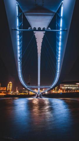 Blue Bridge Over Body Of Water During Night Time Photo Des