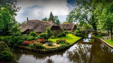 Of Giethoorn Village With Canals And Rustic Thatched Roof