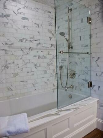 Gorgeous Bathroom With Carrara Marble Subway Tile And Marbled Bath