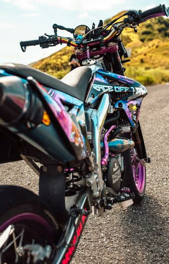Biker Girl On A Rainbow Colored Custom Supermoto With Image