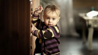 Cute Little Baby Boy Trying To Open Drawer HD Wallpaper