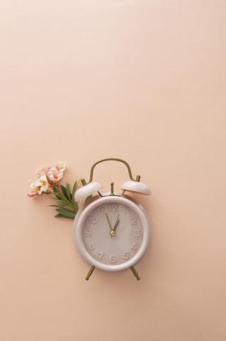 Retro Clock With Flower On Pastel Background Stock Photo