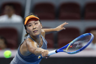 Shuai Peng Powerfully Reaching For A Tennis Ball In Match Wallpaper