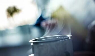 Top Of A Mug Steaming With Blurred Outdoorsy Backgroundteaming