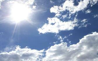Blue Sky With Sun And Clouds Background Image Wallpaper Or Texture