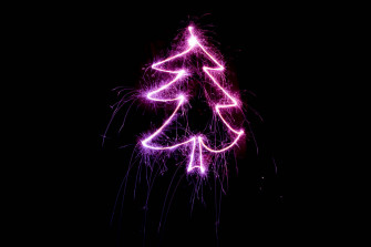 A Magenta Christmas Lights Tree Against Starry Night