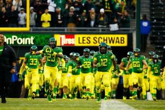 Oregon Ducks Run Into Autzen Stadium Before The Start Of Football