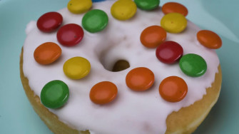 Video Stock Taking Glazed Donut With Colored Chocolates From A Wallpaper
