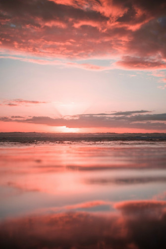 Body Of Water Under White Clouds During Golden Hour Photo