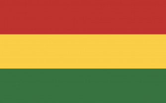A Rastafarian Stands Proud With The Jamaican Flag In