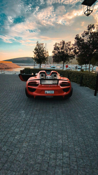 Red Ferrari Car Parked On Gray Concrete Pavement Photo
