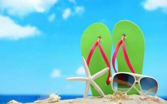 Seashell Starfish Sunglasses And Green Flip Flops In Sand On Beach