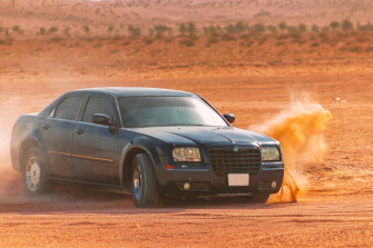 Black Sedan On Brown Field During Daytime Photo Cars