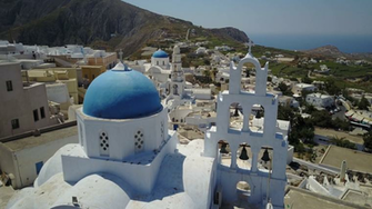 Aerial Footage Of A Church And Cliffside Village In Santorini