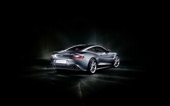 Gray Aston Matin Car In The Stop Black Background And Road