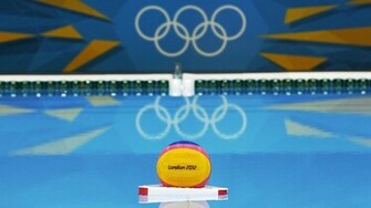 Water Polo Ball Floats In Front Of The Olympic Rings At