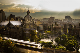 Vibrant Medellin Cityscape With Metro Wallpaper