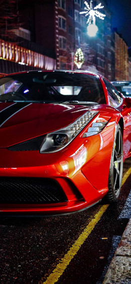 Luxurious Ferrari With iPhone On A City Street Wallpaper