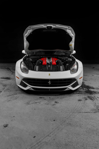 A Sleek White Ferrari Alongside An Immaculate iPhone Wallpaper