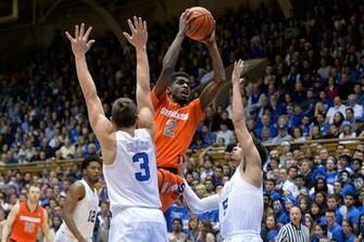 Between Defenders Grayson Allen And Tyus Jones Of The Duke