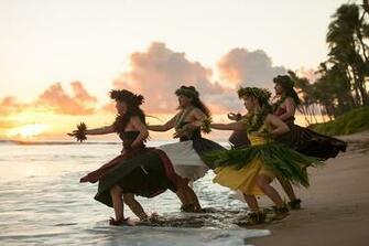 Hawaiian Hula Halau Performs A Traditional Dance At Sunset On The