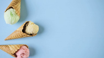 Waffle Ice Cream Cones With Scoops Of On A Blue