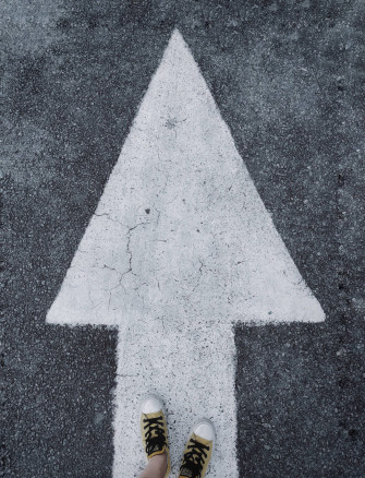 Feet Standing On A White Arrow Wallpaper