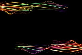 Multi Coloured Twisting Trails Of Light On A Back Backdrop With Plenty